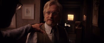 Movie still from “Ant-Man and the Wasp” (2018), directed by Peyton Reed – An older man wearing glasses and a tie; Close Up shot, Over the shoulder angle