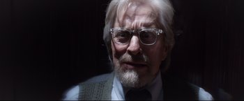 Movie still from “Ant-Man and the Wasp” (2018), directed by Peyton Reed – An old man with a beard wearing glasses and a sweater; Close Up shot, Over the shoulder angle