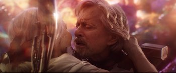 Movie still from “Ant-Man and the Wasp” (2018), directed by Peyton Reed – An older man with long white hair and a white beard is kissing a younger man; Close Up shot, Over the shoulder angle