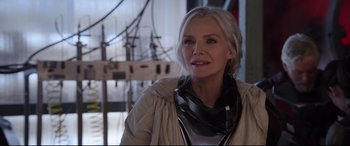 Movie still from “Ant-Man and the Wasp” (2018), directed by Peyton Reed – A woman in a white jacket is looking at the camera; Close Up shot, Over the shoulder angle