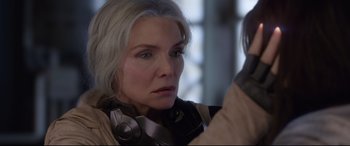 Movie still from “Ant-Man and the Wasp” (2018), directed by Peyton Reed – An older woman wearing headphones looking into a mirror; Close Up shot, Over the shoulder angle