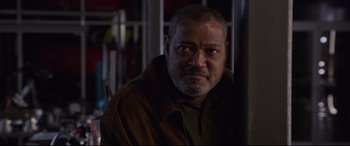 Movie still from “Ant-Man and the Wasp” (2018), directed by Peyton Reed – A man with a beard and a brown jacket is looking at the camera; Close Up shot, Low angle