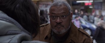 Movie still from “Ant-Man and the Wasp” (2018), directed by Peyton Reed – An older man wearing glasses and a brown jacket looking at the camera; Close Up shot, Over the shoulder angle
