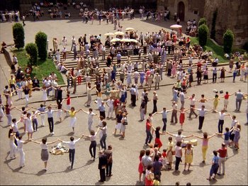 A crowd of people standing on top of a stone floor