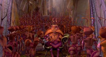 Movie still from “Antz” (1998), directed by Tim Johnson – An image of a group of people that are sitting in a chair; Extreme Wide shot, High angle
