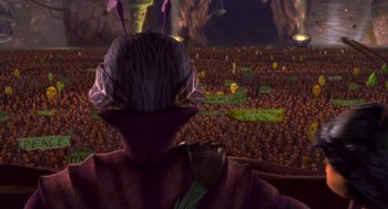 Movie still from “Antz” (1998), directed by Tim Johnson – An image of a person in front of a crowd of people; Extreme Wide shot, High angle