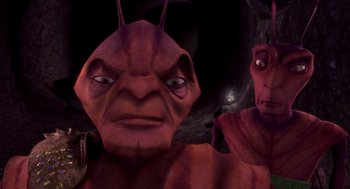 Movie still from “Antz” (1998), directed by Tim Johnson – A red creature with a person in the background; Close Up shot, High angle