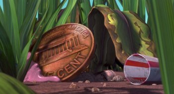 Movie still from “Antz” (1998), directed by Tim Johnson – An image of an image of a coin that has been broken; Extreme Close Up shot, High angle