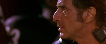 Movie still from “Any Given Sunday” (1999), directed by Oliver Stone – An older man is looking into the distance; Close Up shot, Over the shoulder angle