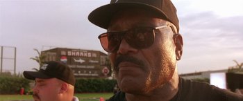 Movie still from “Any Given Sunday” (1999), directed by Oliver Stone – An older man wearing sunglasses and a hat; Close Up shot, Low angle