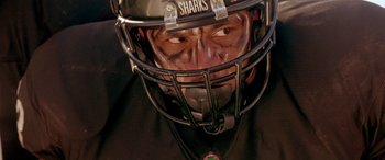 Movie still from “Any Given Sunday” (1999), directed by Oliver Stone – A person wearing a helmet; Close Up shot, High angle
