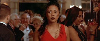 Movie still from “Any Given Sunday” (1999), directed by Oliver Stone – A person wearing a red dress; Close Up shot, Over the shoulder angle