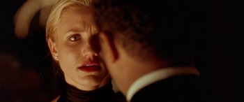 Movie still from “Any Given Sunday” (1999), directed by Oliver Stone – A man and a woman looking into each other's eyes in the dark; Close Up shot, Over the shoulder angle