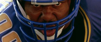 Movie still from “Any Given Sunday” (1999), directed by Oliver Stone – A person wearing a football helmet; Extreme Close Up shot, Overhead angle
