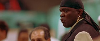 Movie still from “Any Given Sunday” (1999), directed by Oliver Stone – A person wearing a black hat; Close Up shot, Low angle