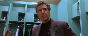 Movie still from “Any Given Sunday” (1999), directed by Oliver Stone – A person wearing a suit and tie; Close Up shot, Low angle