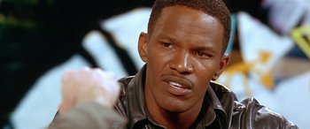 Movie still from “Any Given Sunday” (1999), directed by Oliver Stone – A person wearing a leather jacket; Close Up shot, High angle