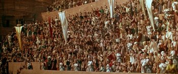 Movie still from “Any Given Sunday” (1999), directed by Oliver Stone – A crowd of people standing on top of a soccer field; Extreme Wide shot, High angle
