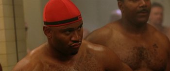Movie still from “Any Given Sunday” (1999), directed by Oliver Stone – A person wearing a red hat; Close Up shot, Over the shoulder angle