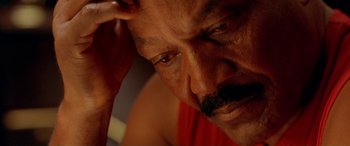 Movie still from “Any Given Sunday” (1999), directed by Oliver Stone – An older man with a mustache is looking at the camera; Close Up shot, High angle