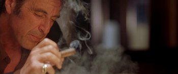 Movie still from “Any Given Sunday” (1999), directed by Oliver Stone – A person smoking a cigarette in a room; Extreme Close Up shot, Low angle