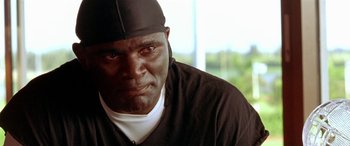 Movie still from “Any Given Sunday” (1999), directed by Oliver Stone – A person wearing a hat; Close Up shot, Low angle