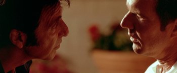 Movie still from “Any Given Sunday” (1999), directed by Oliver Stone – A man looking at another man with his finger pointed at him; Close Up shot, Over the shoulder angle