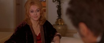 Movie still from “Any Given Sunday” (1999), directed by Oliver Stone – A person sitting on a couch in a living room; Close Up shot, Over the shoulder angle