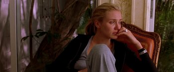 Movie still from “Any Given Sunday” (1999), directed by Oliver Stone – A woman leaning on a wall with her hand on her face; Close Up shot, Over the shoulder angle
