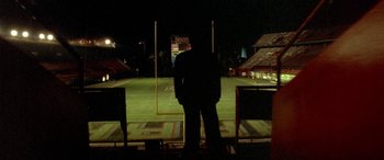 Movie still from “Any Given Sunday” (1999), directed by Oliver Stone – Two people standing on a field at night; Extreme Wide shot, High angle