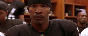 Movie still from “Any Given Sunday” (1999), directed by Oliver Stone – A person wearing a black shirt; Close Up shot, High angle