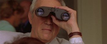Movie still from “Any Given Sunday” (1999), directed by Oliver Stone – An older man looking through a pair of binoculars; Close Up shot, Low angle