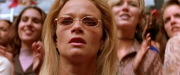 Movie still from “Any Given Sunday” (1999), directed by Oliver Stone – A woman wearing sunglasses and looking to her left; Close Up shot, Low angle