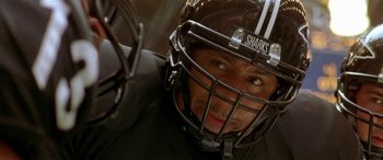 Movie still from “Any Given Sunday” (1999), directed by Oliver Stone – A person wearing a football helmet; Close Up shot, High angle