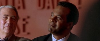 Movie still from “Any Given Sunday” (1999), directed by Oliver Stone – A person wearing a suit and tie; Close Up shot, Low angle
