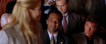 Movie still from “Any Given Sunday” (1999), directed by Oliver Stone – Two men and a woman in business suits; Close Up shot, Over the shoulder angle