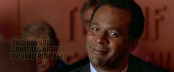 Movie still from “Any Given Sunday” (1999), directed by Oliver Stone – A person wearing a suit and tie; Close Up shot, Low angle