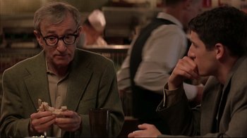 Movie still from “Anything Else” (2003), directed by Woody Allen – Two men are sitting at a table and one is eating a sandwich; Medium shot, Over the shoulder angle