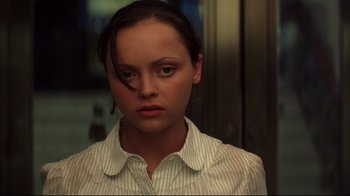 Movie still from “Anything Else” (2003), directed by Woody Allen – A young woman with short brown hair wearing a striped shirt; Close Up shot, High angle