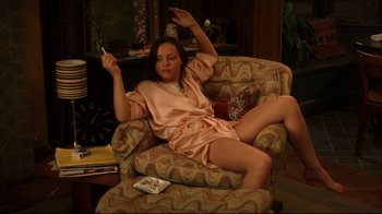 Movie still from “Anything Else” (2003), directed by Woody Allen – A woman sitting on a chair in a living room; Medium shot, High angle