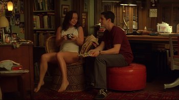Movie still from “Anything Else” (2003), directed by Woody Allen – A man and a woman sitting in a chair in a room; Wide shot, High angle
