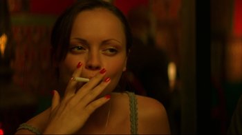 Movie still from “Anything Else” (2003), directed by Woody Allen – A woman smoking a cigarette while sitting in a room; Close Up shot, High angle