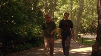 Movie still from “Anything Else” (2003), directed by Woody Allen – Two men walking down a sidewalk near a forest; Medium shot, Low angle