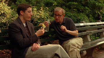 Movie still from “Anything Else” (2003), directed by Woody Allen – Two men sitting on a park bench eating and drinking; Medium shot, Over the shoulder angle