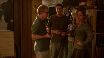 Movie still from “Anything Else” (2003), directed by Woody Allen – A group of people standing in a room; Medium shot, Over the shoulder angle
