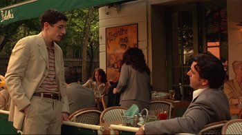 Movie still from “Anything Else” (2003), directed by Woody Allen – A group of people sitting at tables outside of a restaurant; Medium shot, Over the shoulder angle