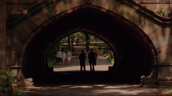 Movie still from “Anything Else” (2003), directed by Woody Allen – A group of people standing under an archway in a park; Extreme Wide shot, High angle