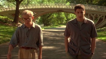 Movie still from “Anything Else” (2003), directed by Woody Allen – Two men are standing in a park near a bridge; Medium shot, Low angle