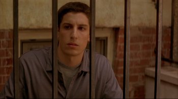 Movie still from “Anything Else” (2003), directed by Woody Allen – A man sitting behind bars in front of a window; Close Up shot, High angle