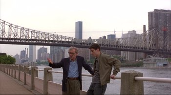 Movie still from “Anything Else” (2003), directed by Woody Allen – Two men standing next to each other near a body of water; Wide shot, Over the shoulder angle